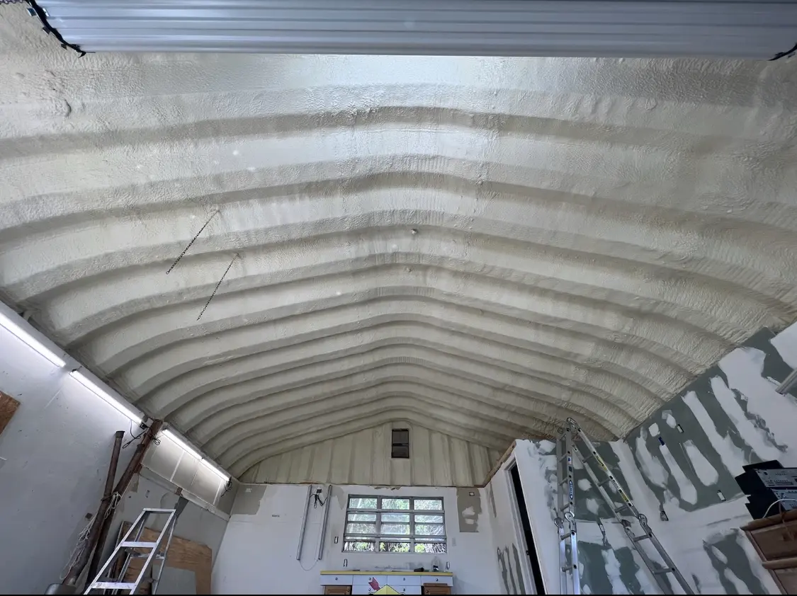 Spray polyurethane foam applied to the underside of a metal roof deck in Perry